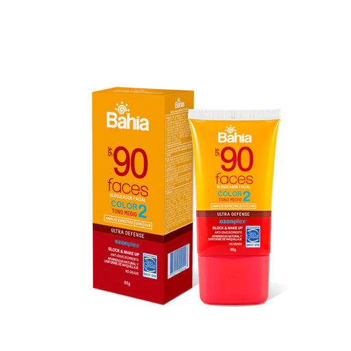 Envase de bloqueador facial Bahia Faces FPS 90 con color, tono medio.